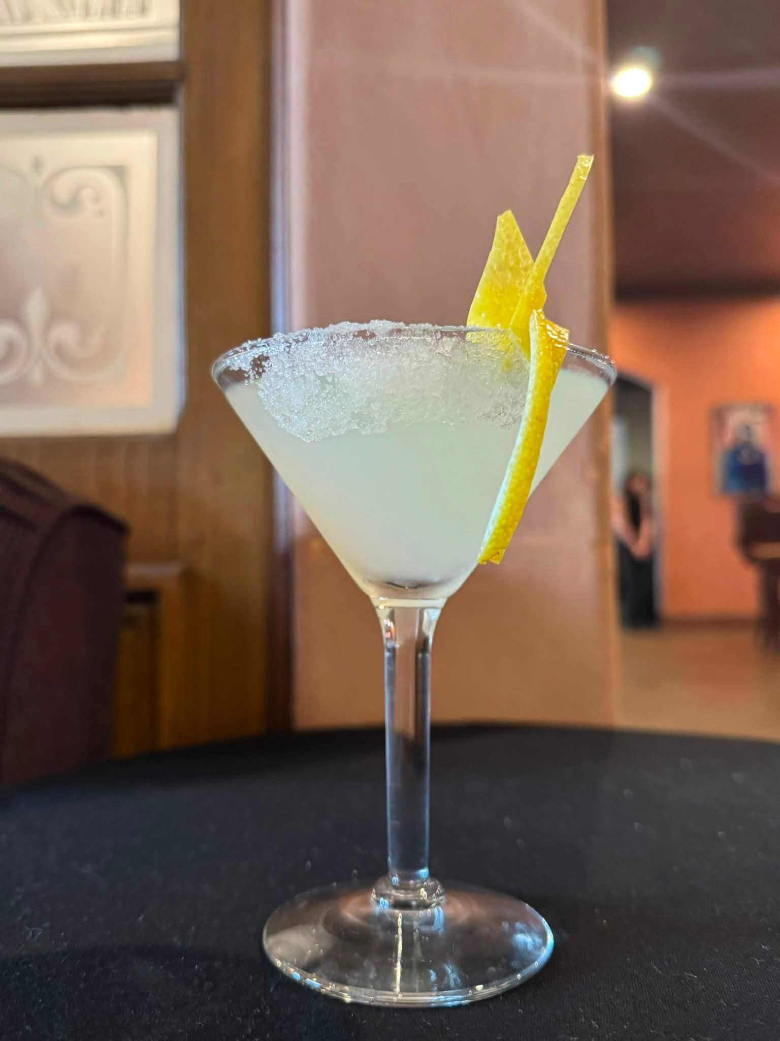 Citrus cocktail with a sugared rim and lemon peel